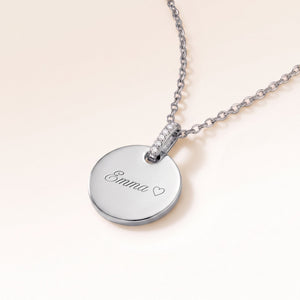 Runt silverhalsband med zirkoner sett från sidan med graverat namn och hjärta
