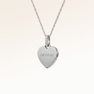 Personalized heart-shaped silver necklace with white zircons and space for engraving of text, coordinates or handwriting on the front and back