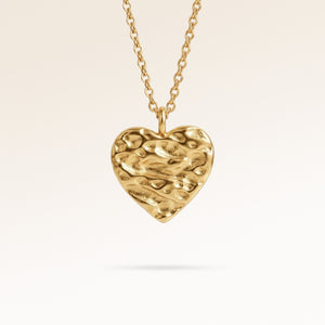Personalized heart-shaped gold necklace with softly melted finish and space for engraving of text, coordinates or handwriting on the back